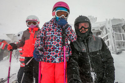 Father with daughters wearing ski wear during winter