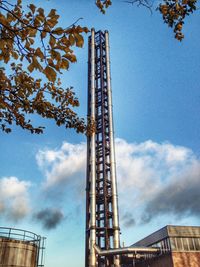 Low angle view of tower against cloudy sky