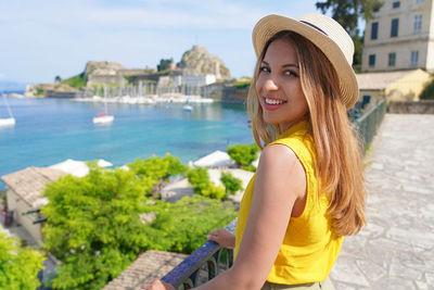 Portrait of young attractive woman looking at camera. smiling girl in corfu, greece.