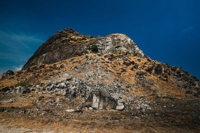 Scenic view of mountain against blue sky