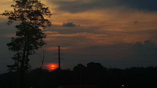 Low angle view of silhouette trees against romantic sky