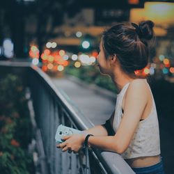 Close-up of woman standing on bench