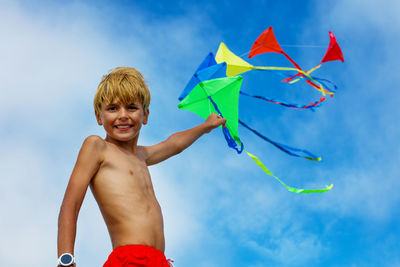 Low angle view of young woman with umbrella