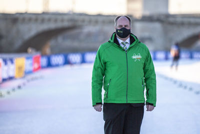 Man with umbrella standing in winter