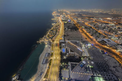 High angle view of city lit up at night