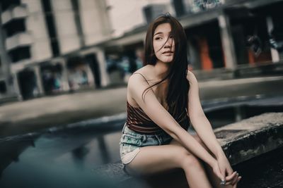 Young woman sitting in a city