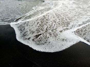 High angle view of wet sand on beach