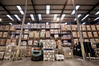 Forklift truck parked at fully stocked warehouse in london