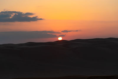 Scenic view of silhouette landscape against romantic sky at sunset