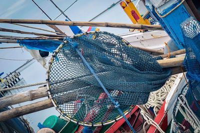 Close-up of fishing net on boat moored at harbor