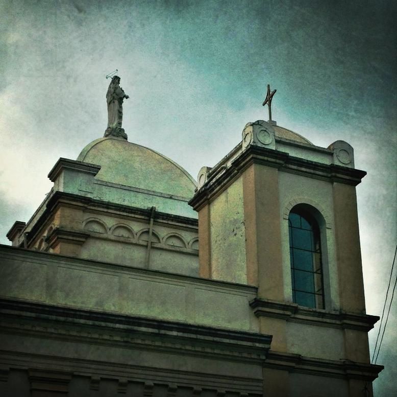 low angle view, building exterior, architecture, built structure, sky, church, religion, place of worship, spirituality, cross, cloud - sky, high section, cloud, day, window, outdoors, no people, facade