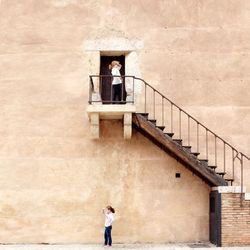 Full length of man standing in front of building