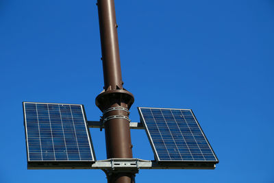 Low angle view of solar panel against clear blue sky