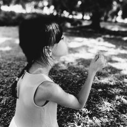 Rear view of girl with horse in water