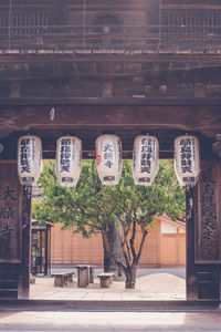 Text hanging outside building at entrance of temple