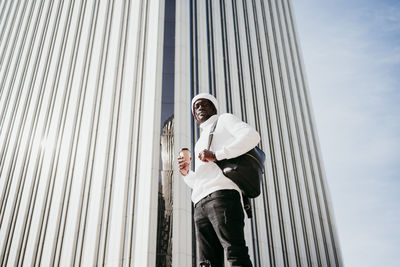 Low angle view of man standing against building