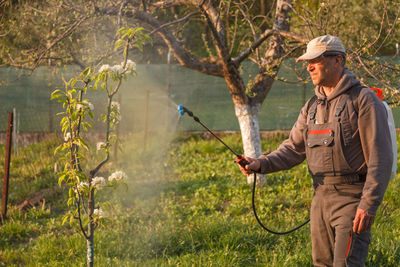 Man spraying insecticide on plants