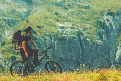 Man riding bicycle on field