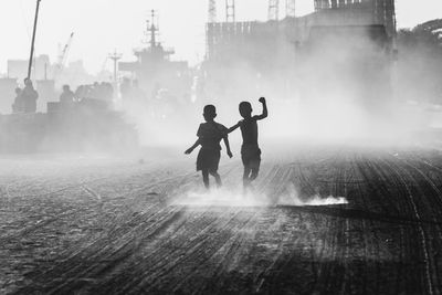 Silhouette boys walking outdoors