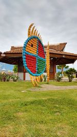 Built structure on field against sky