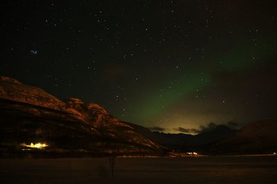 Scenic view of mountains against sky at night