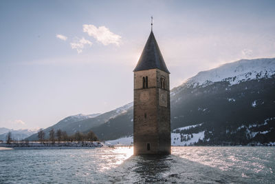 Church by building against sky