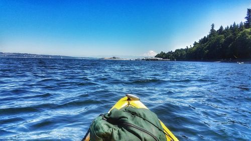 Close-up of yellow blue sea against clear sky