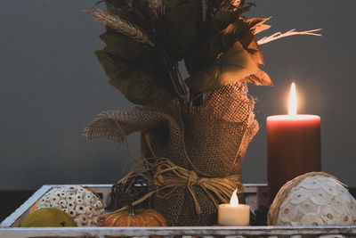 Close-up of lit candles on table