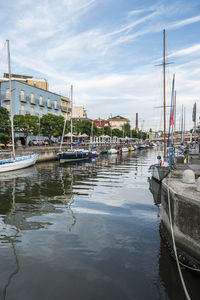 The canal that divides cattolica from gabicce with the buildings that are reflected in the water