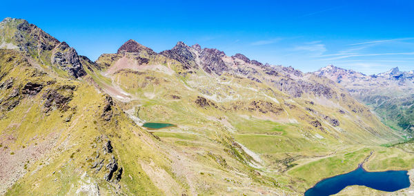 Scenic view of mountains against blue sky