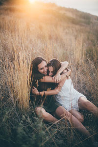 Happy young woman relaxing on field