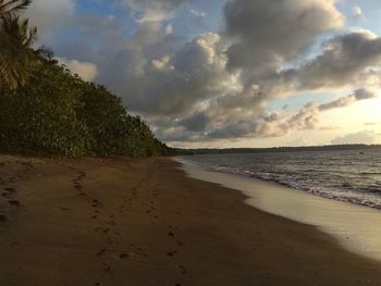 Scenic view of beach against sky during sunset