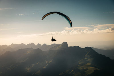 Person paragliding against sky