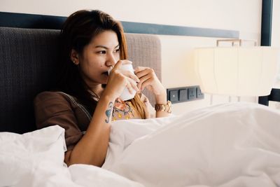 Woman sitting on bed