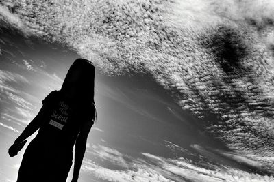 Silhouette of woman against sky