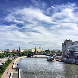 Bridge over river against cloudy sky