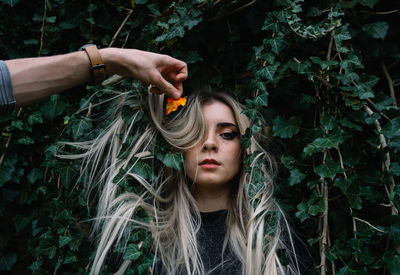 Cropped hand holding autumn leaf by woman