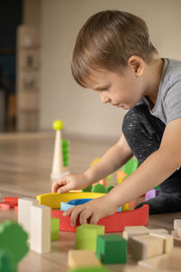 Boy playing with toy blocks at home