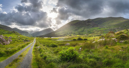 Straight country road leading trough black valley, macgillycuddys reeks mountains, ireland