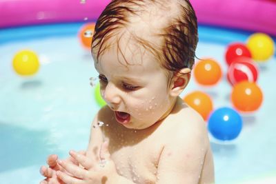 Shirtless baby boy in swimming pool