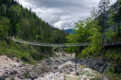 Scenic view of bridge over mountains against sky