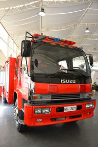 Red truck on road in city