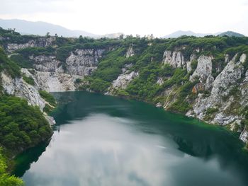 Scenic view of river amidst mountains against sky