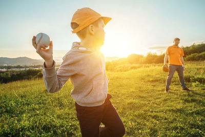 Father and son playing in baseball. man teaching boy baseballs exercise. family sports father's day.