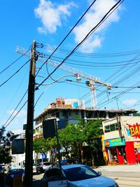 Electricity pylon against cloudy sky