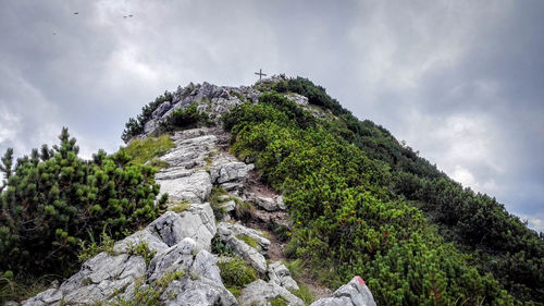 Low angle view of mountain against cloudy sky