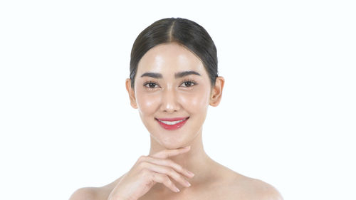 Portrait of a smiling young woman over white background