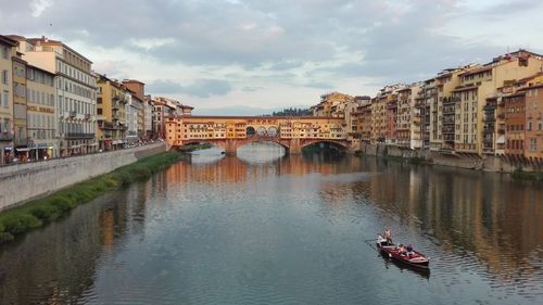 Boats in river with buildings in background