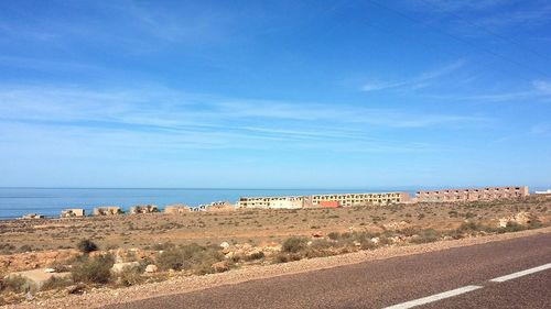 Scenic view of beach against blue sky