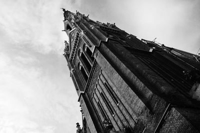 Low angle view of building against cloudy sky